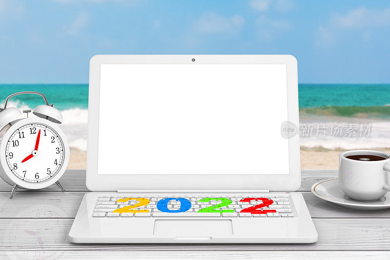 Modern Laptop with New 2022 Year Sign, Cup of Coffee and Alarm Clock in front of Ocean. 3d渲染